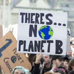 Demonstrators in the street with message There Is no Planet B on a placard.